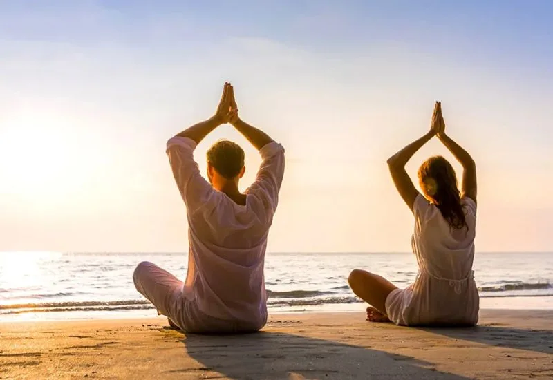 Beach yoga session near resorts near morjim beach goa sunrise view
