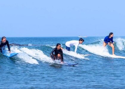 Surfing activity near resorts close to Morjim Beach
