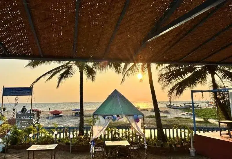 Beachside dining setup at one of the best resorts in Morjim Goa during sunset