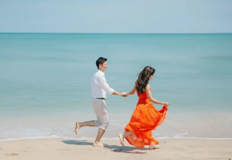 Romantic couple walk near morjim beach resort