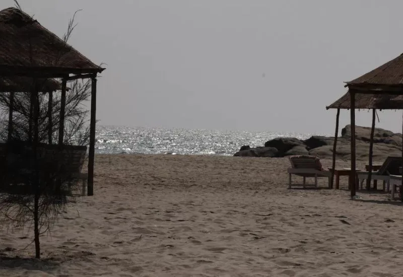 Peaceful beach view near morjim beach resort with huts